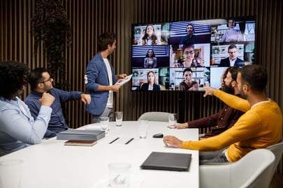 Professionals in a meeting room on a conference call